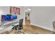 Home office features two monitors, hardwood floors, neutral paint, and view into the dining room at 2721 Jazzy St, New Hill, NC 27562