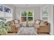 Cozy sunroom filled with natural light, comfortable seating, and views of the backyard at 2721 Jazzy St, New Hill, NC 27562