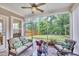 Inviting screened porch boasts comfortable seating, ceiling fan, and serene backyard views at 2721 Jazzy St, New Hill, NC 27562
