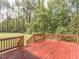 Picture of a large, stained wooden deck overlooking a spacious lawn surrounded by lush trees at 30 Cole Creek Way, Franklinton, NC 27525