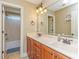 Bathroom showcasing a double vanity with wood cabinets, a large mirror, and an adjoining shower/bath area at 30 Cole Creek Way, Franklinton, NC 27525