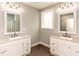 Well-lit bathroom featuring dual sinks, white cabinets, grey walls, and unique hexagonal tile flooring at 30 Cole Creek Way, Franklinton, NC 27525