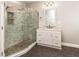 Modern bathroom boasting a glass door shower with marble tile and pebble floor, complemented by a white vanity at 30 Cole Creek Way, Franklinton, NC 27525