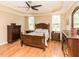 Comfortable bedroom featuring hardwood floors, a ceiling fan, and matching dark wood furniture at 30 Cole Creek Way, Franklinton, NC 27525