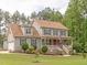 Charming two-story home featuring a welcoming front porch, manicured lawn, and classic architectural details at 30 Cole Creek Way, Franklinton, NC 27525