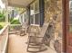 Charming front porch with rocking chairs and stone accents, perfect for relaxing outdoors at 30 Cole Creek Way, Franklinton, NC 27525