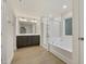 Beautiful bathroom featuring a double vanity, bathtub, and glass shower at 304 Ford Meadows Dr, Garner, NC 27529