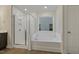 Bathroom with glass shower, bathtub, and bright window at 304 Ford Meadows Dr, Garner, NC 27529