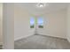 Bright bedroom with carpeted floors and two windows allowing for natural light at 304 Ford Meadows Dr, Garner, NC 27529