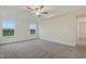 Bedroom with plush carpet, tray ceilings, and bright windows at 304 Ford Meadows Dr, Garner, NC 27529