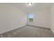 This carpeted bedroom boasts neutral walls and a window with wooded views at 304 Ford Meadows Dr, Garner, NC 27529