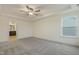 Bedroom with plush carpet, ceiling fan, and attached bathroom at 304 Ford Meadows Dr, Garner, NC 27529