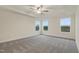 Bright bedroom featuring tray ceiling, ceiling fan, and large windows at 304 Ford Meadows Dr, Garner, NC 27529