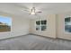Bright bonus room with carpet, ceiling fan, and multiple windows for ample light at 304 Ford Meadows Dr, Garner, NC 27529