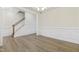 Elegant dining room featuring hardwood floors, wainscoting, and a modern chandelier at 304 Ford Meadows Dr, Garner, NC 27529