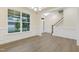 Open-concept dining area featuring hardwood floors, elegant trim, and natural light with a view to the front yard at 304 Ford Meadows Dr, Garner, NC 27529