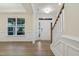 Inviting entryway with hardwood floors, wainscoting and trim, leading into a sun-filled living space at 304 Ford Meadows Dr, Garner, NC 27529