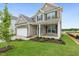 Attractive two-story home showcasing a combination of brick and siding, a two-car garage, and manicured landscaping at 304 Ford Meadows Dr, Garner, NC 27529