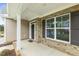 Covered front porch area of a home with brick columns and dark shutters at 304 Ford Meadows Dr, Garner, NC 27529