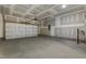 Spacious two-car garage with concrete floor, unfinished drywall, and garage door opener at 304 Ford Meadows Dr, Garner, NC 27529