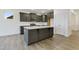 Stylish kitchen with a central island, ample storage, and modern stainless steel appliances at 304 Ford Meadows Dr, Garner, NC 27529