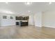 Open-concept kitchen with gray cabinets, stainless appliances, island, and hardwood floors at 304 Ford Meadows Dr, Garner, NC 27529