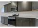 This modern kitchen includes stainless steel appliances, ample cabinet space and sleek countertops at 304 Ford Meadows Dr, Garner, NC 27529