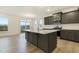 Modern kitchen featuring a central island, granite countertops, and stainless steel appliances at 304 Ford Meadows Dr, Garner, NC 27529