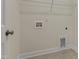 This tiled laundry room includes base trim and a wall-mounted shelf at 304 Ford Meadows Dr, Garner, NC 27529