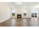 Light filled living room features a fireplace, neutral walls, wood grain floors and outdoor access at 304 Ford Meadows Dr, Garner, NC 27529