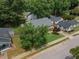 Aerial view of home with a green lawn, established trees, and surrounding neighborhood at 304 S Smith St, Clayton, NC 27520