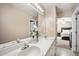 This bathroom features dual sinks with white cabinets beneath and a large mirror with vanity lighting at 304 S Smith St, Clayton, NC 27520