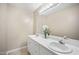 This bathroom features dual sinks with white cabinets beneath and a large mirror with vanity lighting at 304 S Smith St, Clayton, NC 27520