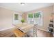 Bright dining room with a farmhouse table, white chairs, and natural light from the window at 304 S Smith St, Clayton, NC 27520