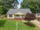 Aerial view of home featuring a well-manicured lawn, front porch, and mature landscaping at 304 S Smith St, Clayton, NC 27520