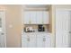 Built-in kitchen cabinet offers plenty of storage with white doors and drawers and gold handles at 304 S Smith St, Clayton, NC 27520