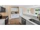 Modern kitchen features white cabinetry, stainless steel appliances, and wood-look flooring at 304 S Smith St, Clayton, NC 27520
