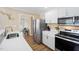 Stylish kitchen with stainless steel appliances and bright white countertops and cabinets at 304 S Smith St, Clayton, NC 27520