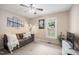 Cozy living room with a comfortable sofa, ceiling fan and natural light from the window at 304 S Smith St, Clayton, NC 27520
