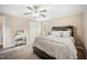 Bright bedroom features a rustic wood bed frame, soft carpet, and a vanity table with mirror at 304 S Smith St, Clayton, NC 27520