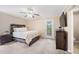 Relaxing bedroom features a rustic wood bed frame, soft carpet, and a door leading to the outdoors at 304 S Smith St, Clayton, NC 27520