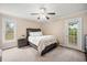 Cozy bedroom features a rustic wood bed frame, soft carpet, and a door leading to the outdoors at 304 S Smith St, Clayton, NC 27520