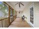 Long porch area showcases a wooden frame, natural light, and a table set providing a cozy space at 304 S Smith St, Clayton, NC 27520