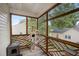 Enclosed porch area showcases a wooden frame, natural light, and a cat tree providing a cozy pet-friendly space at 304 S Smith St, Clayton, NC 27520