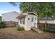Detached backyard shed featuring windows, door, and adjacent fencing at 304 S Smith St, Clayton, NC 27520