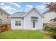 This backyard features a well-maintained lawn and a partial view of the house with siding and a small porch at 307 Millbrook Dr, Pittsboro, NC 27312