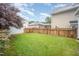 Spacious backyard featuring a well-kept lawn, bordered by a wooden fence for privacy and aesthetic appeal at 307 Millbrook Dr, Pittsboro, NC 27312