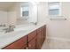 A double vanity bathroom features two windows and a long countertop at 307 Millbrook Dr, Pittsboro, NC 27312