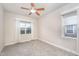 Bright bedroom featuring neutral carpet, a ceiling fan, and a window with curtains for ample natural light at 307 Millbrook Dr, Pittsboro, NC 27312