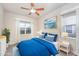 This primary bedroom features two large windows and modern decor at 307 Millbrook Dr, Pittsboro, NC 27312
